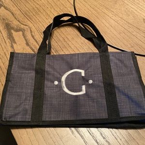 Small cute tote bag with pockets. It has letter “C” on it.
